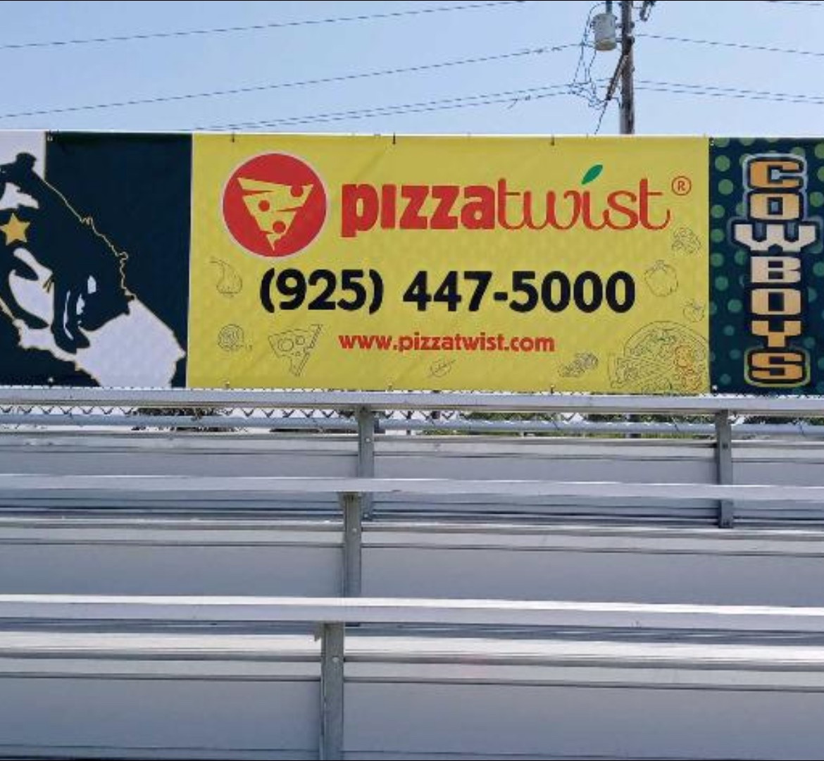 Pizza Twist sponsor banner installed above school bleachers